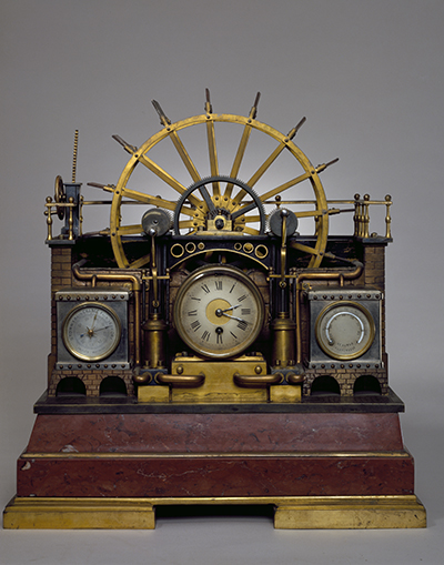 Metal clock with piston wheels, barometer and thermometer